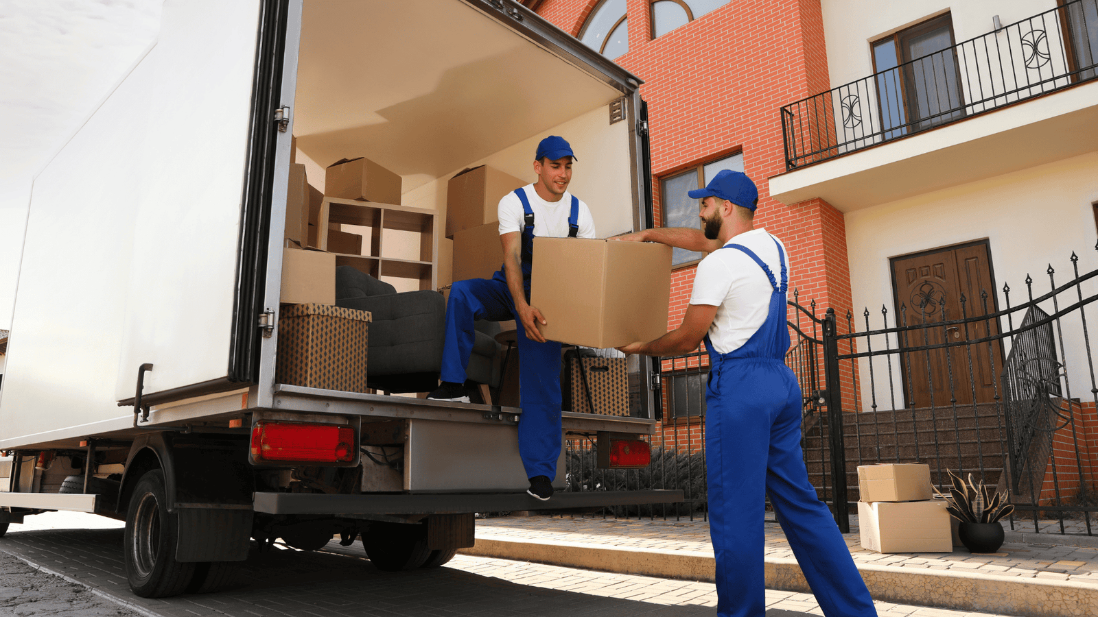 Professional movers loading boxes into a truck