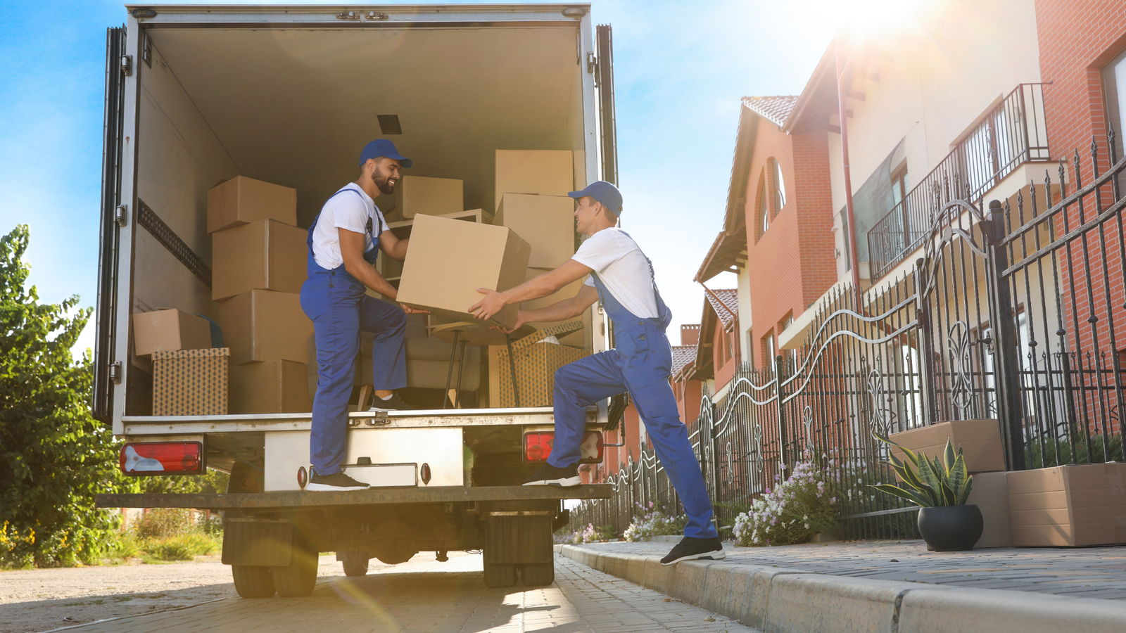 Professional movers loading boxes into a truck